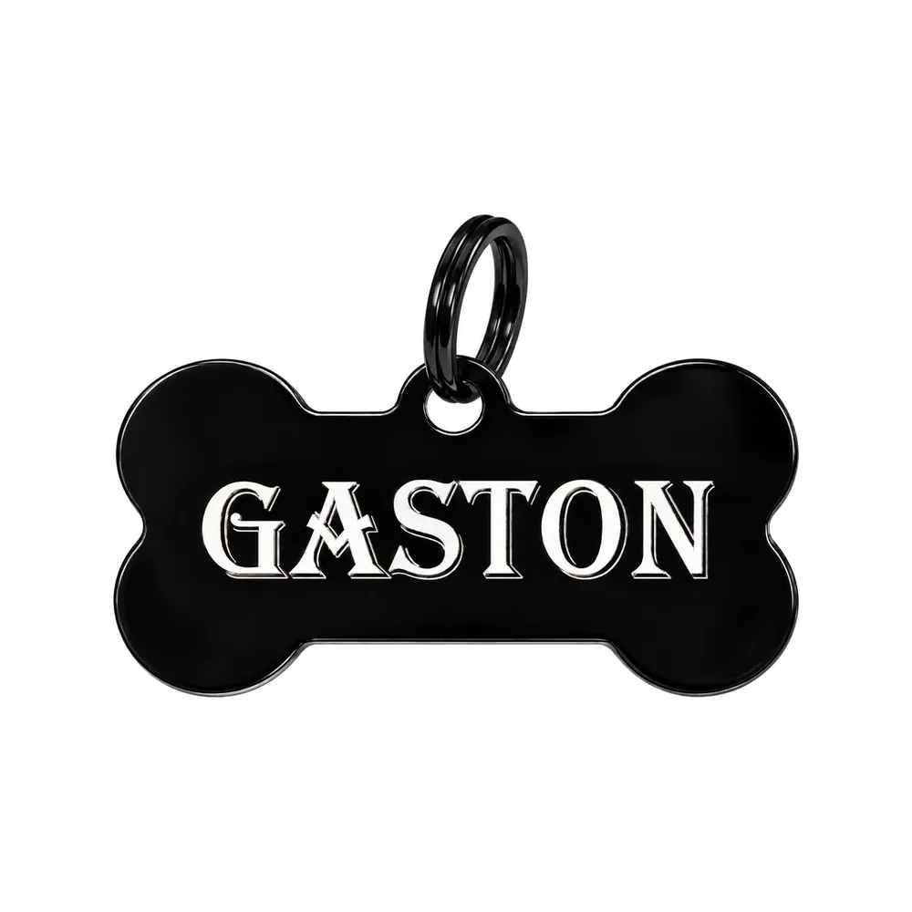 Médaille os noire gravée du prénom Gaston en lettres blanches, avec anneau noir
